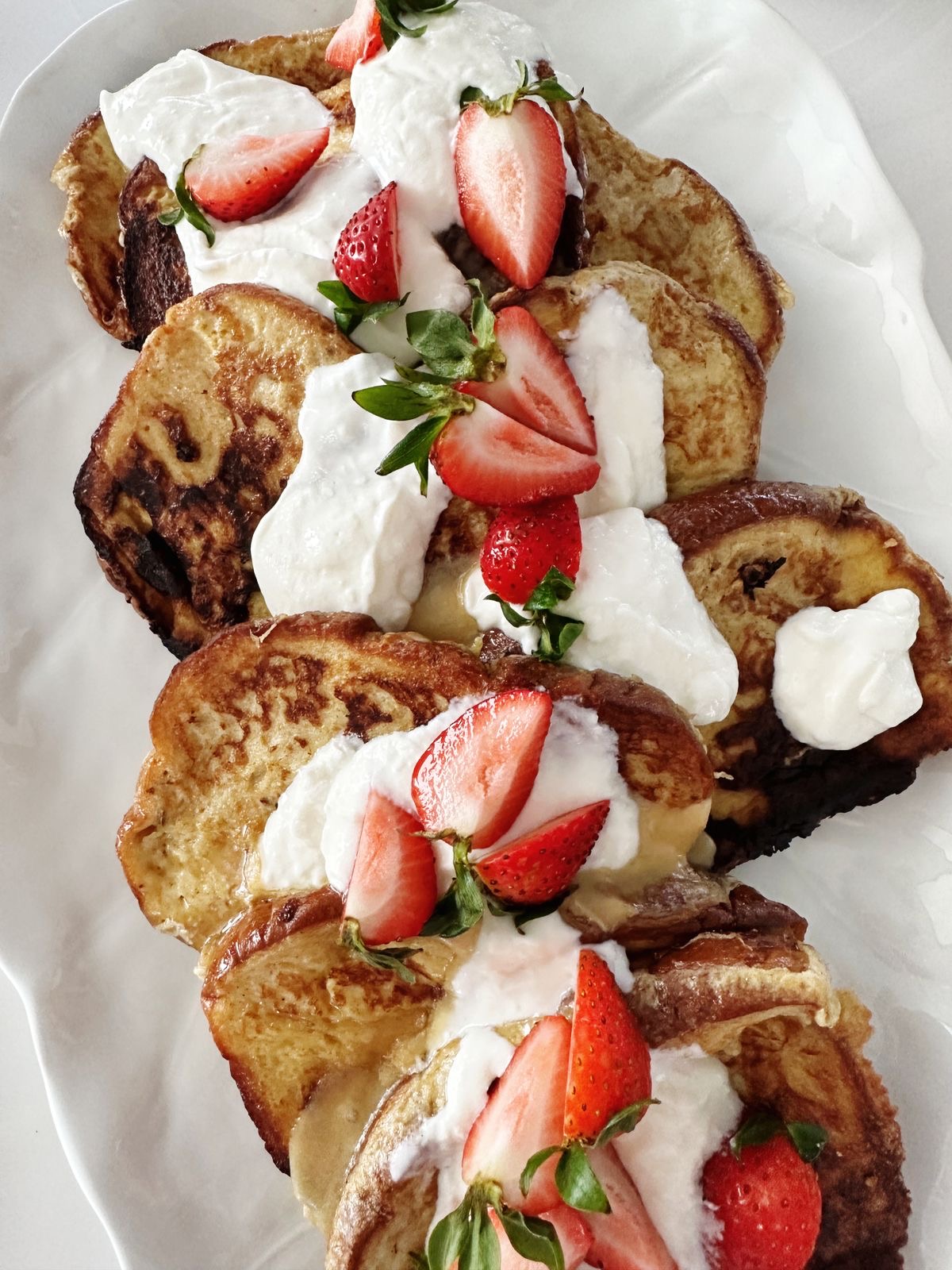 French toast with cream, syrup and strawberries